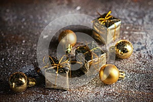 Christmas present mini golden box in the snow background. Close up. Christmas holiday celebration and new year concept. Winter hol