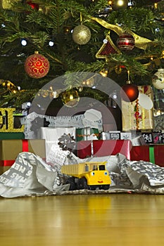 Christmas present unwrapped under a christmas tree