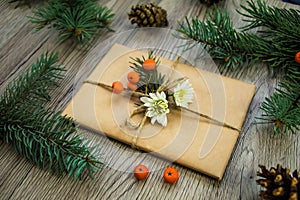 Christmas present wrapped in eco paper with natural decoration. Angle view