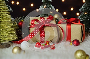 Christmas presents with decor on white wool against shiny bokeh lights background