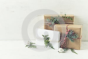 Christmas presents decorated with natural evergreen twigs and cinnamon stick. Copy space