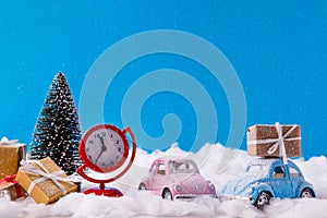 Christmas presents delivering. Santa claus ad his small helper drive pink blue cars from snowy north-pole hurry for