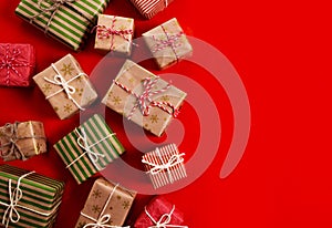 Christmas presents gifts on a red background. Simple, classic red and white wrapped gift boxes with ribbon bows and holiday