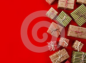Christmas presents gifts on a red background. Simple, classic red and white wrapped gift boxes with ribbon bows and holiday