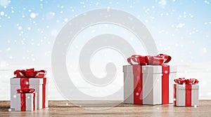 Christmas presents on wooden floor with blurred snowflakes background 3d-illustration