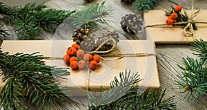 Christmas presents wrapped in kraft paper with natural decoration. Angle view