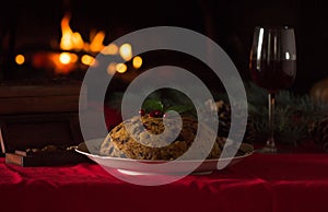 Christmas pudding and christmas light on wooden table