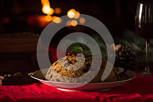 Christmas pudding and christmas light on wooden table