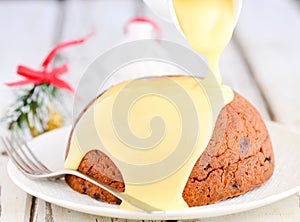 Christmas pudding with custard photo