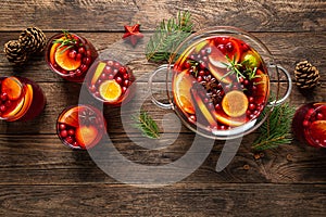 Christmas punch. Festive red cocktail, drink with cranberries and citrus fruits in a punch bowl and glasses