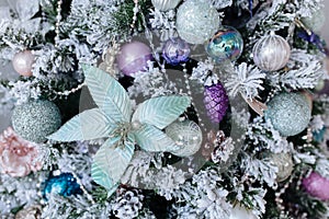 Christmas purple and silver decorations on the Christmas tree, snowflakes balls garlands, closeup texture background