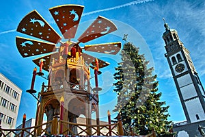 Christmas pyramid and tree at market square low-angle photo