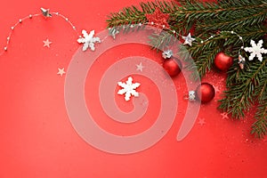 Christmas red background with beautiful green needle twigs