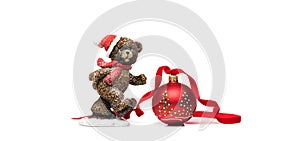 Christmas red ball with ribbon and funny bear on a white background.