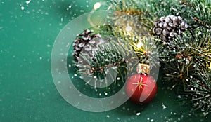 Christmas red ball, Christmas tree, ornaments and defocused lights background on green background. Concept: Christmas and New Year