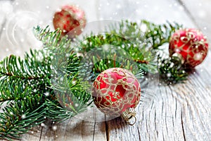 Christmas red balls with gold ornaments and spruce branch.