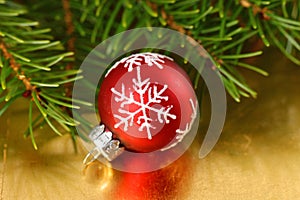 Christmas red bauble with snowflake ornament on gold background