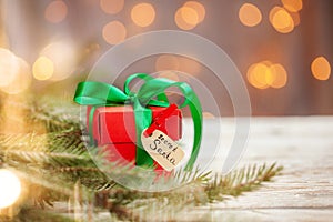 Christmas red box or present for secret santa on wooden table