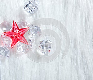 Christmas red crystal star on ice cubes and fur