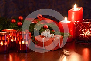 Christmas red gift box with spruce branch and burning candles stock images