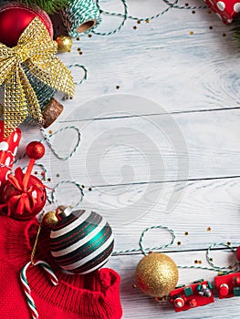 Christmas red, green and golden golden ornament frame on wooden background. New year festive mood