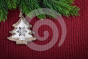 Christmas red knitted background with christmas tree decoration in country farmhouse style