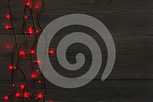 Christmas red lights border on grey wooden background