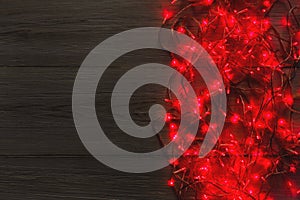 Christmas red lights border on grey wooden background