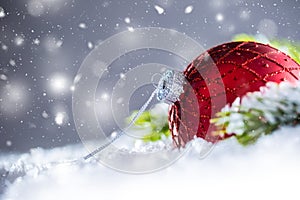 Christmas red Luxury ball in snow and abstract snowy atmosphere