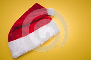 Christmas red Santa Claus hat with white pompom yellow . Decoration background