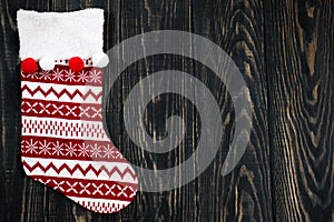 Christmas red sock on a wooden background