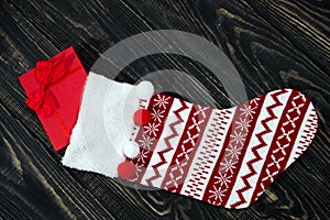 Christmas red sock on a wooden background