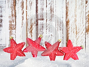 Christmas red stars decorations and wooden background