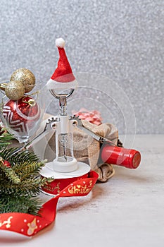 Christmas Red wine and wine opener with santa hat decoration on table