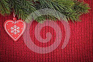 Christmas red wool background with traditional tree decoration in a farmhouse style