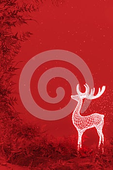 Christmas reindeer glowing decoration with copy space on red background.