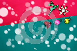 Christmas reindeer snowflake fruits and bell on Red green background with snow fall,top view with copy space