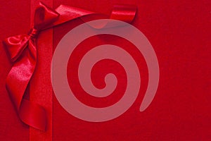 Christmas ribbon with bow on red fabric