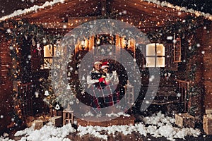 Christmas romance in Santa Claus hats beautiful house New Year`s atmosphere