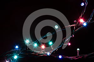 Christmas romantic decorative garland lights frame on black background with copy space