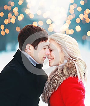 Christmas romantic sensual couple in love to cold winter over celebration bokeh, gentle kiss moment