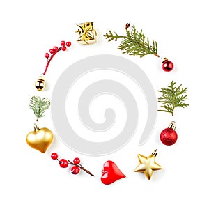 Christmas round frame composition with holly berries, red baubles, golden star, gift and green fir branch isolated on white