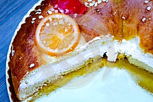 Christmas round fruit cake decorated with fir tree branch, glazed fruits and nuts