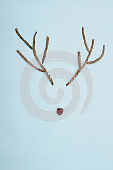 Christmas rudolf reindeer antlers and cherry nose on blue