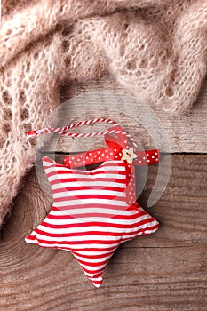 Christmas rustic background - vintage planked wood with woolen scarf and handcraft decorative toy star and free text space