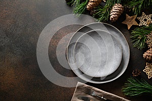 Christmas rustic home table setting with empty gray plate and xmas wooden decor