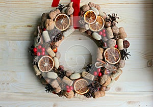 Christmas in a rustic style. Handmade decor. Christmas wreath on the background of old boards. Festive mood.