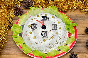 The Christmas salad rice olives greens peas - concept New year clock face, midnight, brown wooden background spruce