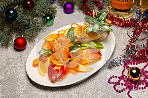 Christmas Salad Set with Quail, Salmon, Fruits and Vegetables Top View. Beautiful New Year Table with Winter Decorations, Flat Lay