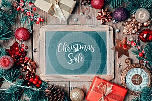 Christmas sale background with chalkboard and ornaments.
